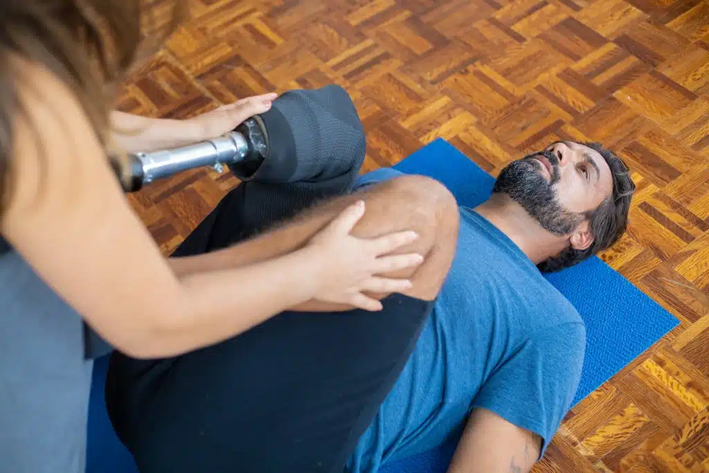 Man with prosthetic leg receiving therapy indoors, aiding recovery and rehabilitation.